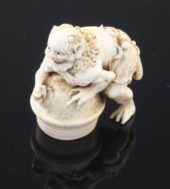 A Japanese ivory netsuke of an oni leaning on a cooking cauldron for rice, signed Tomomasa, 19th century, 4cm, loss to one toe